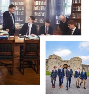 Three well-dressed students from a boarding school for boys study with two older men in a library, then walk together in suits outside near a stone castle under a blue sky.